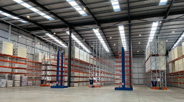 Fully stocked warehouse with lots of racking