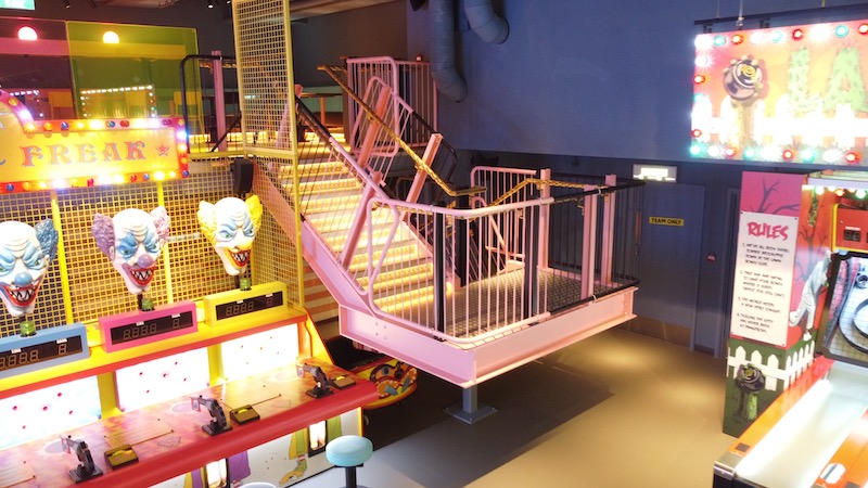 Entertainment venue mezzanine staircase in pink with pink handrails